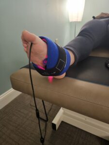 Close-up of a foot using a red light therapy device for targeted pain relief and improved healing